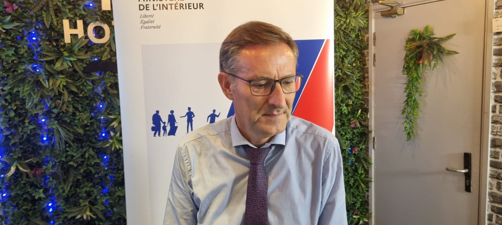Un intervenant devant le visuel de la Semaine de l’intégration.